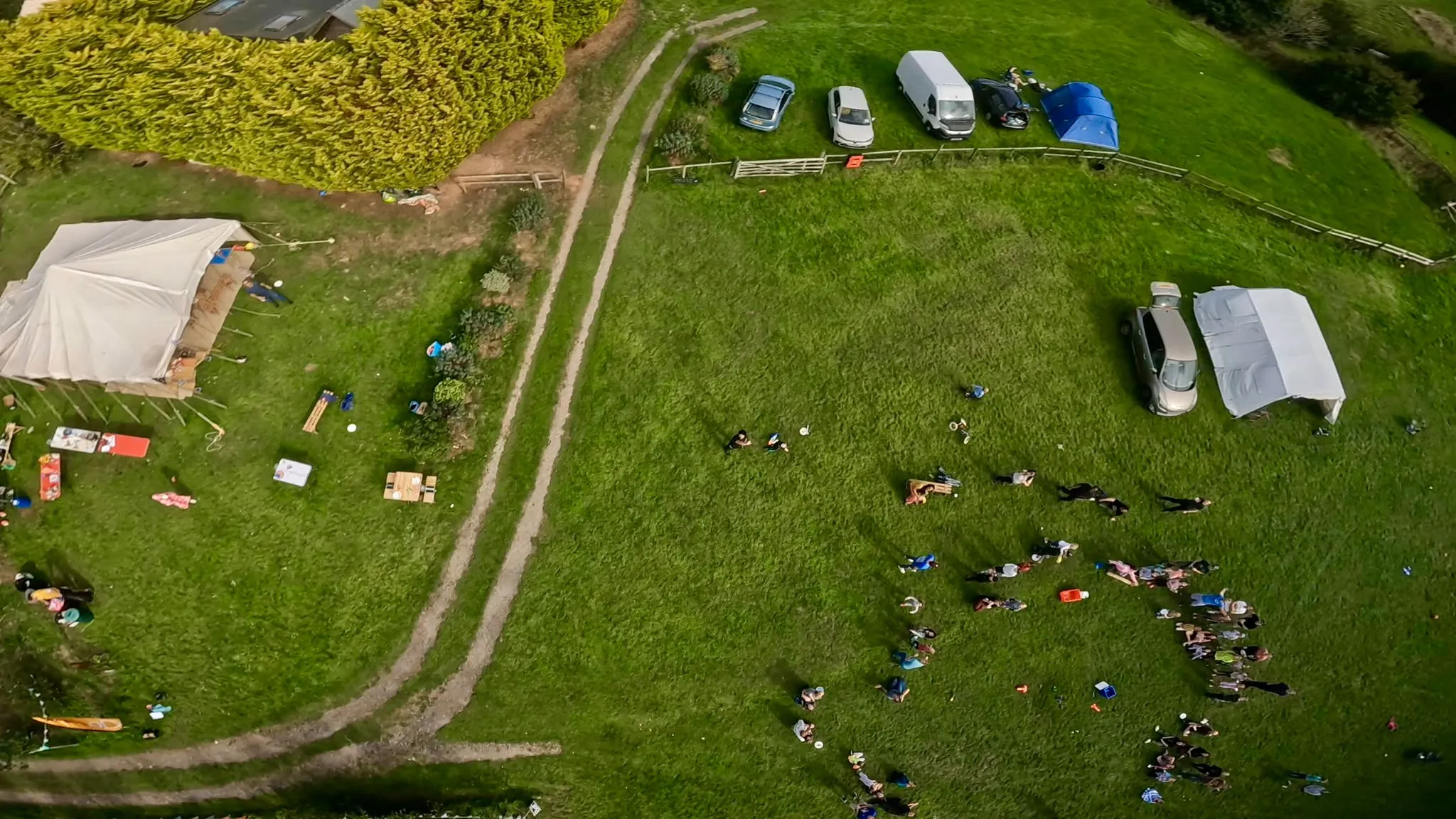 The DadFest site from the air — a marquee, camping and families across a green field
